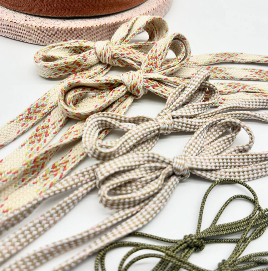 Round laces in white and green, made at SCF Braiding Workshop Paris